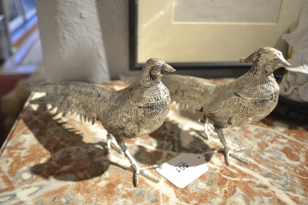 A pair of white metal studies of cock pheasants, 20th century. L.28cm