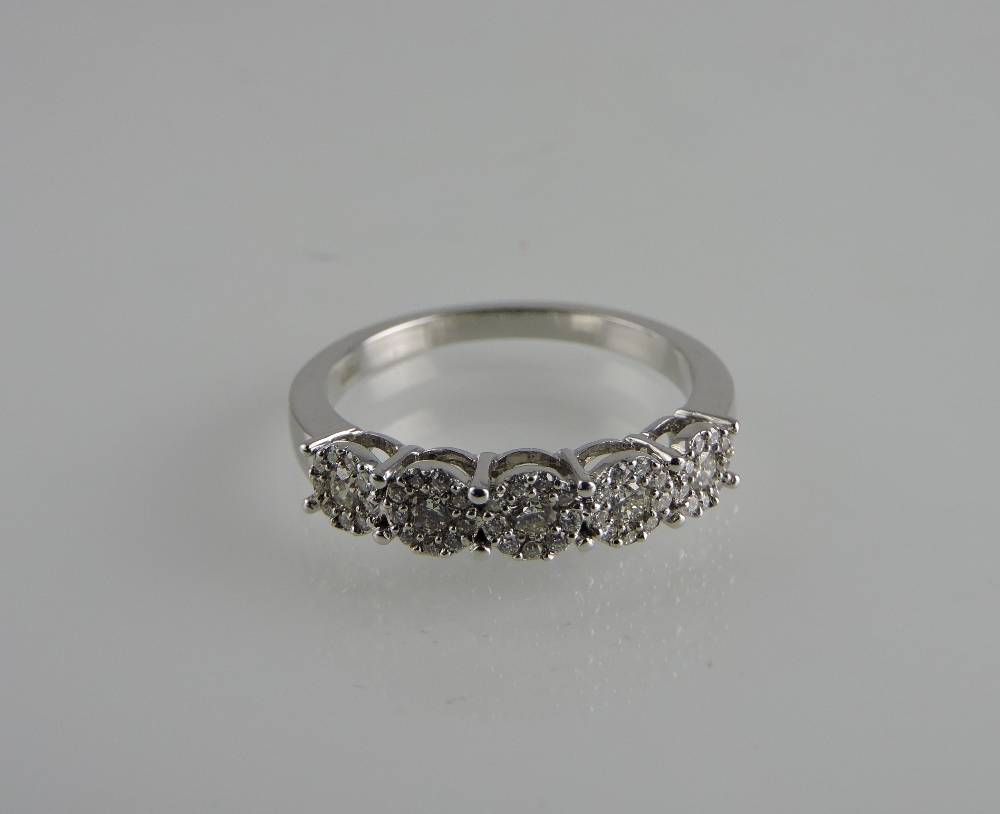 An 18ct white gold diamond cluster half-eternity ring, total weight 0.38ct.