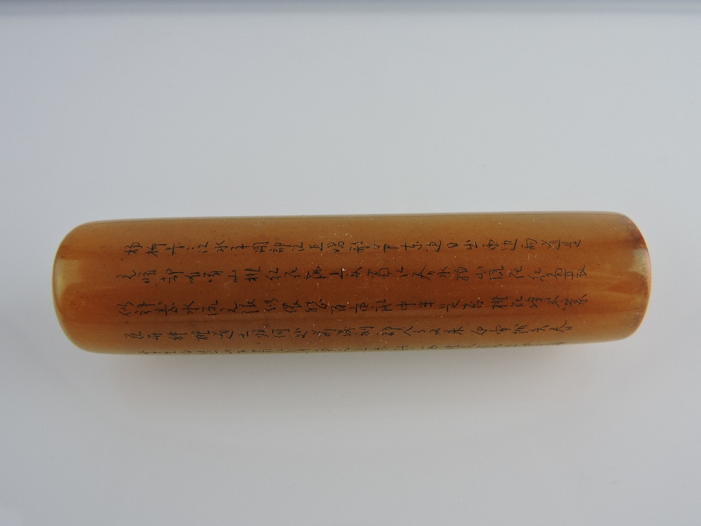 A Chinese yellow soap stone cylinder seal, finely carved with characters, L 8cm.