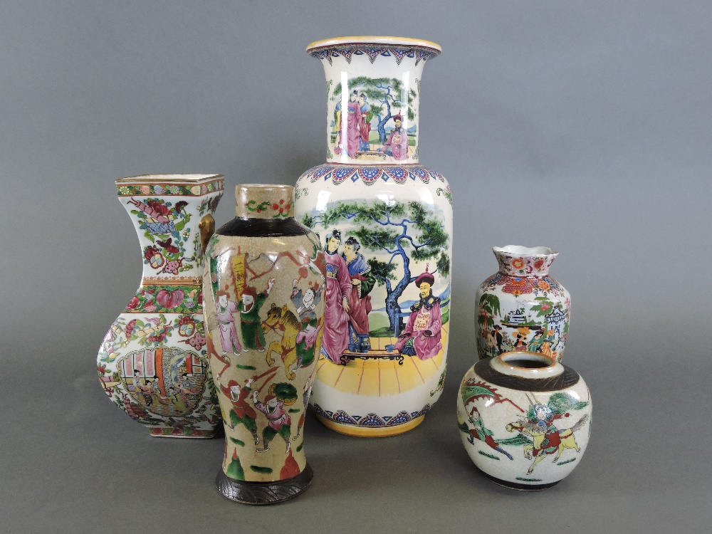 A 20th Century famille rose square baluter shape vase, decorated with vignettes of flowers and