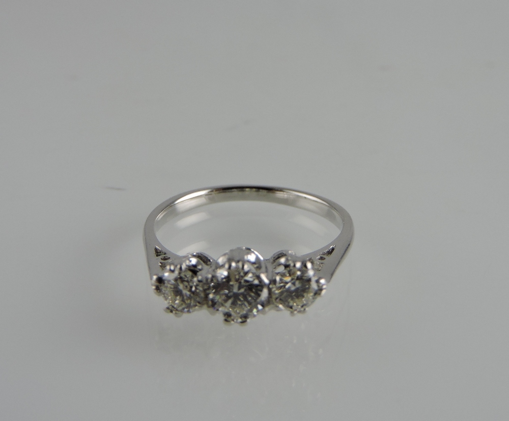 An 18ct white gold three-stone diamond ring, claw set, total weight 0.73ct.