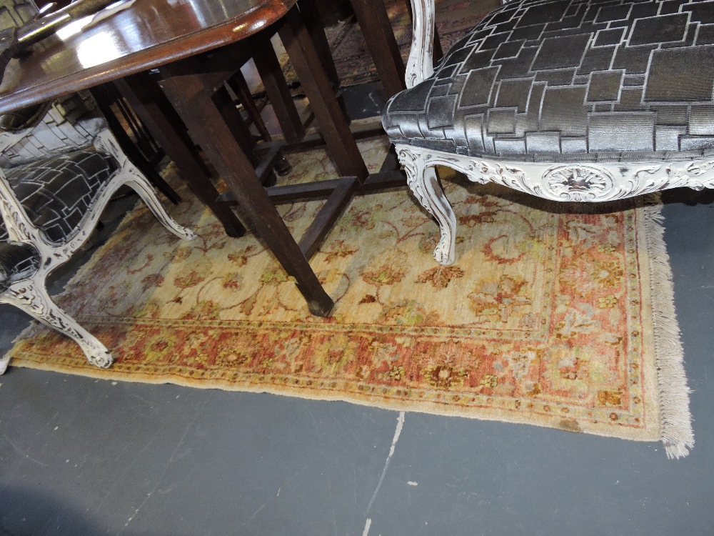 A zeigler ivory ground rug woven with trailing flowers.