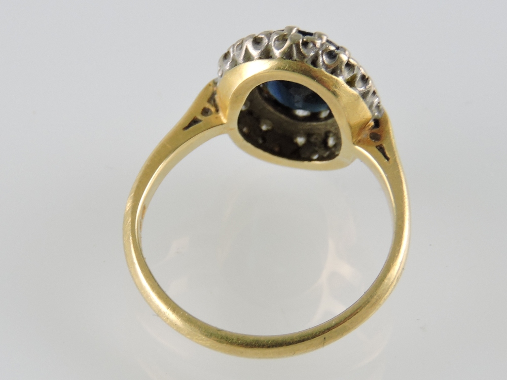 An 18ct gold ring claw set with an oval sapphire within a diamond border, together with a pair of - Image 2 of 2