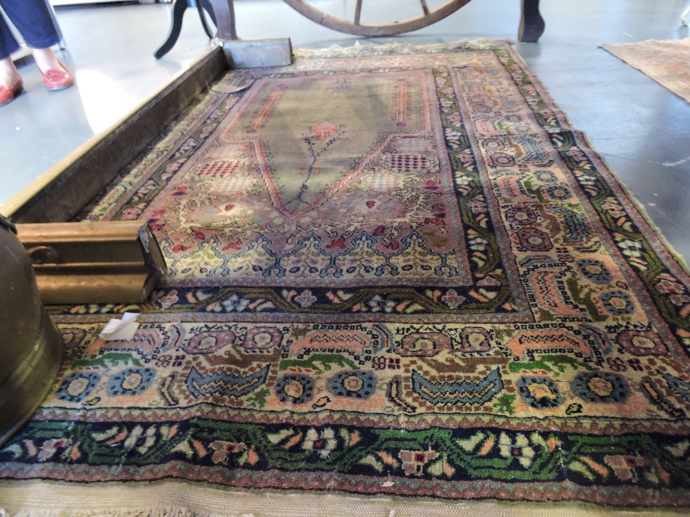 A Kashan style pale green ground prayer rug within a wide geometric border.