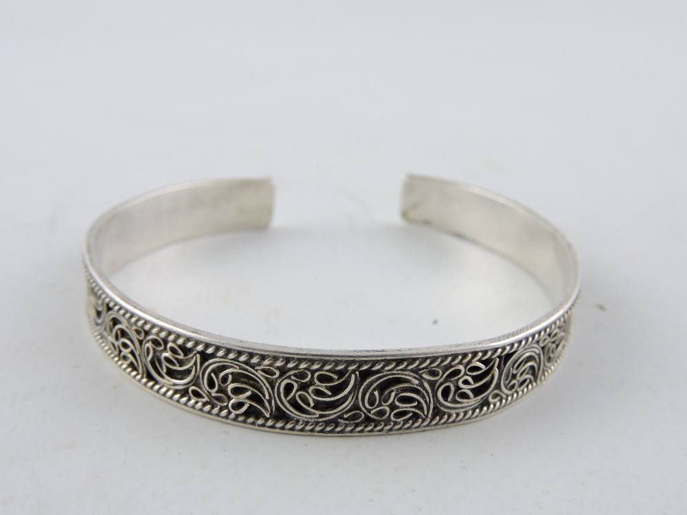 An engraved silver hinged bangle together with two further silver bangles. - Image 3 of 4