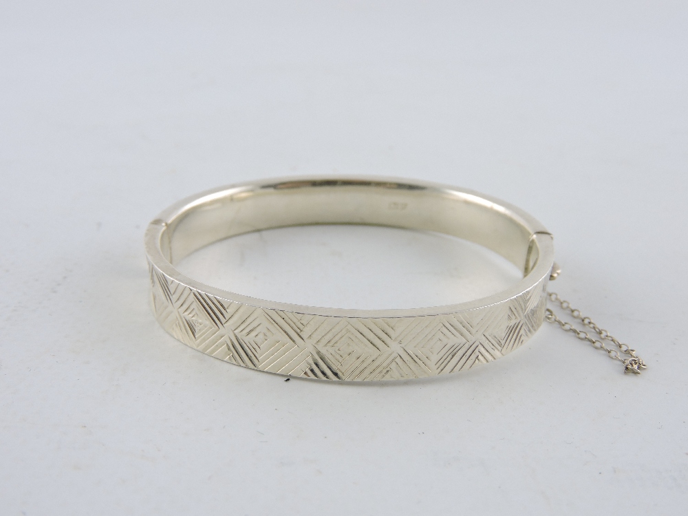 An engraved silver hinged bangle together with two further silver bangles. - Image 4 of 4