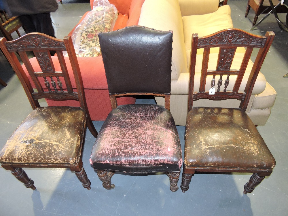 A pair of late Victorian carved mahogany dining chairs, together wit a Victorian oak dining chair.