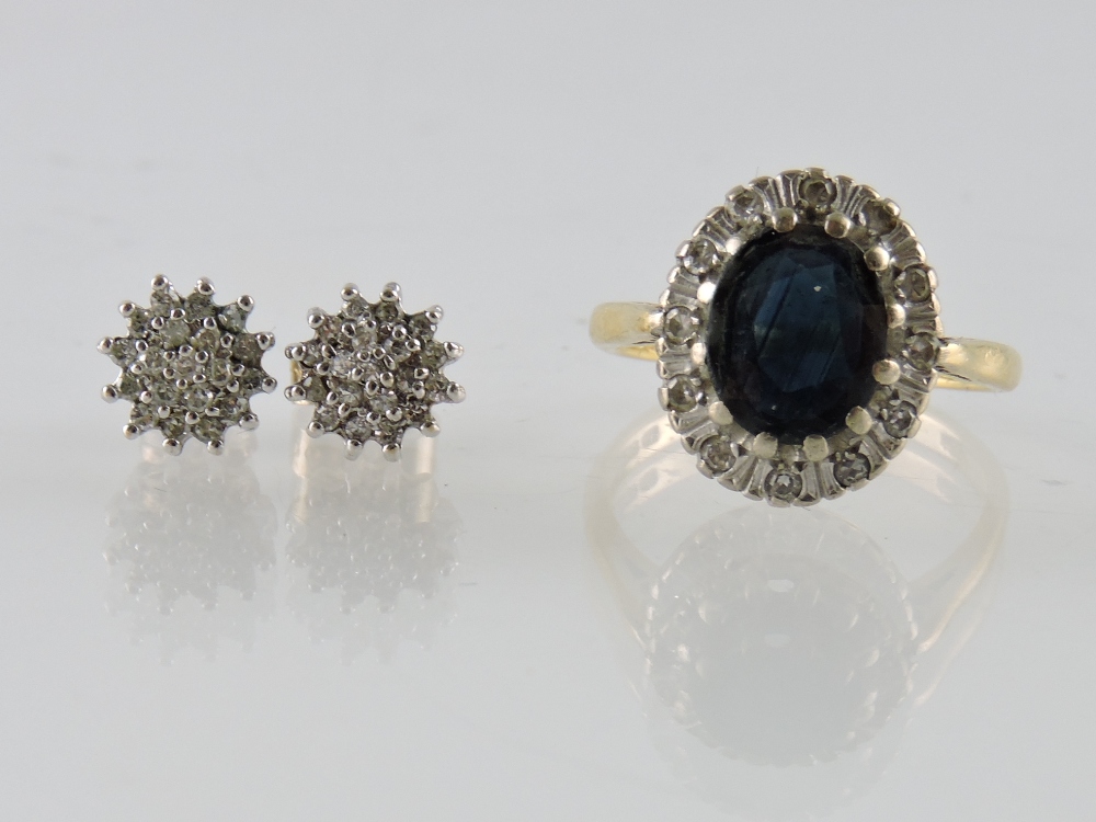 An 18ct gold ring claw set with an oval sapphire within a diamond border, together with a pair of