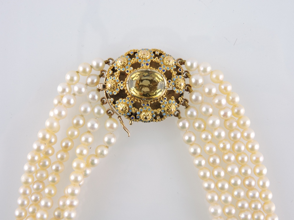 A five strand cultured pearl necklace, the oval enamelled yellow metal clasp set with a central - Image 3 of 3