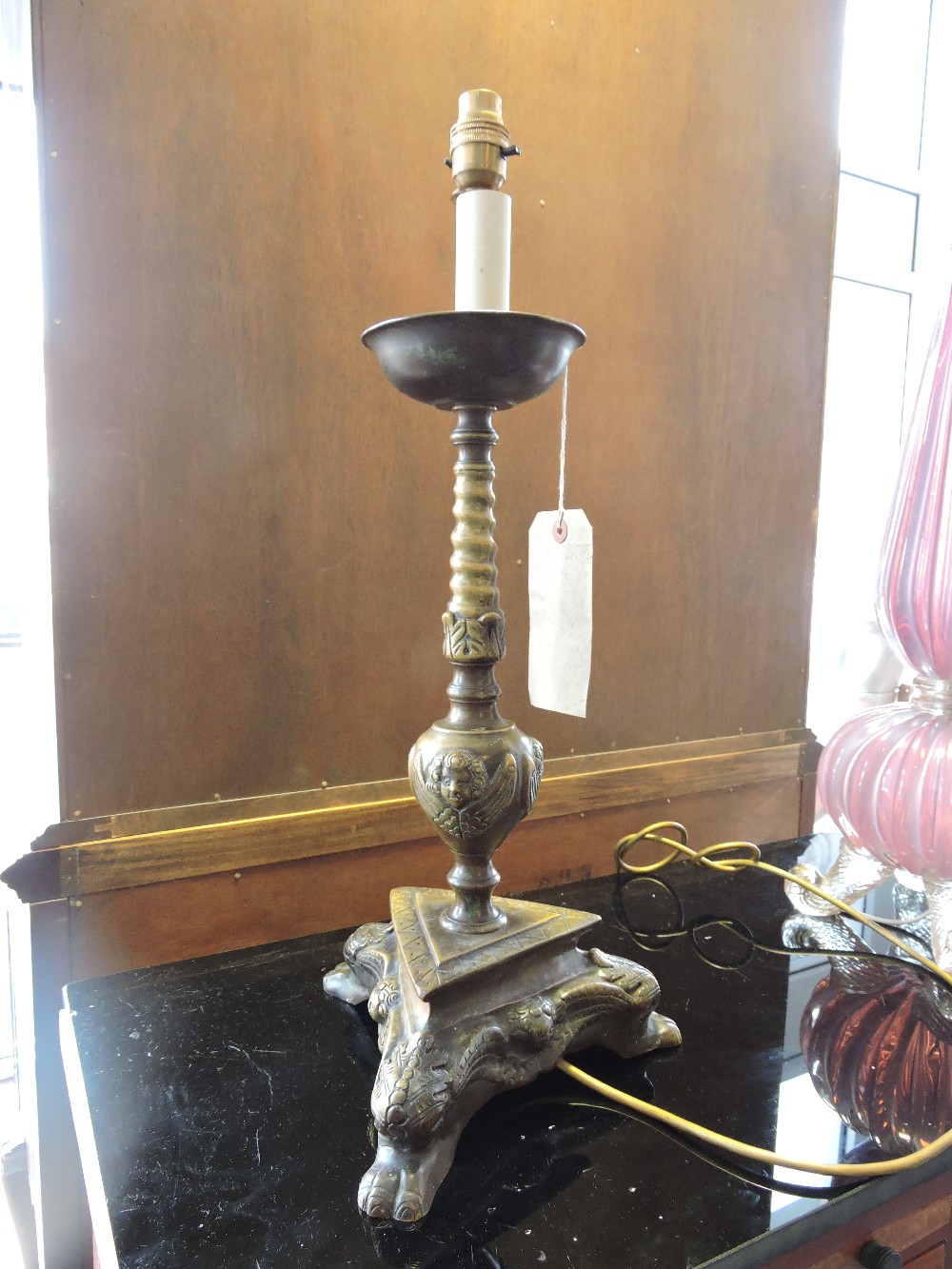 An unusual Dutch style bronze table lamp with spiral pillar and triangular platform base cast