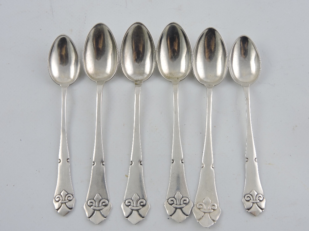 A set of six Danish silver teaspoons with cast stylised fleur de lys finials.