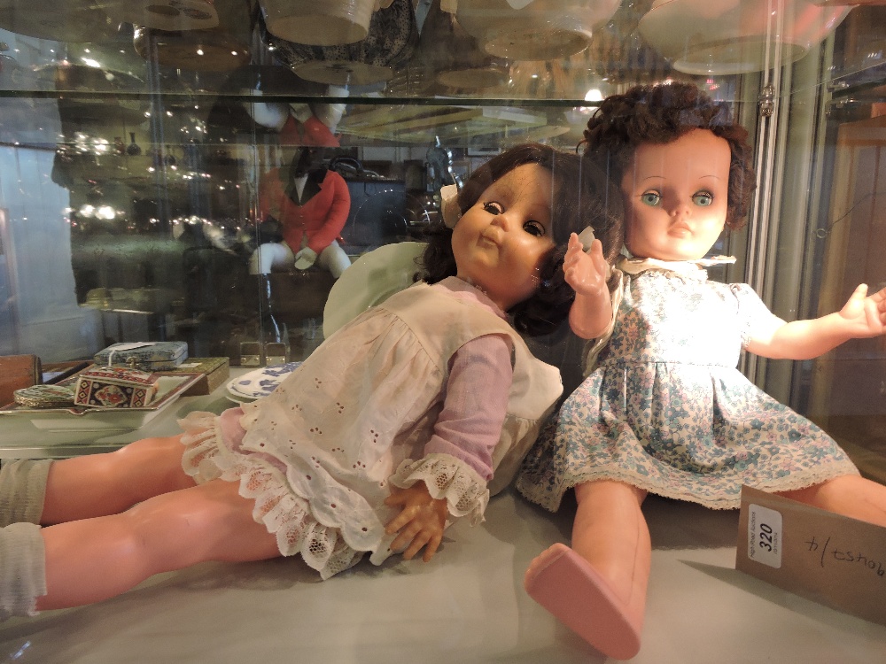 Two 1950s celluloid dolls with sleeping eyes.