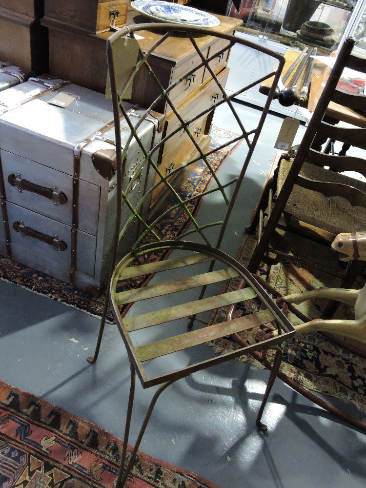 A set of four French vintage style distressed metal garden chairs.