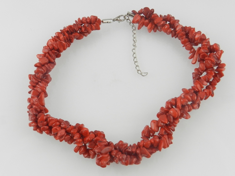 A three strand coral bead necklace.