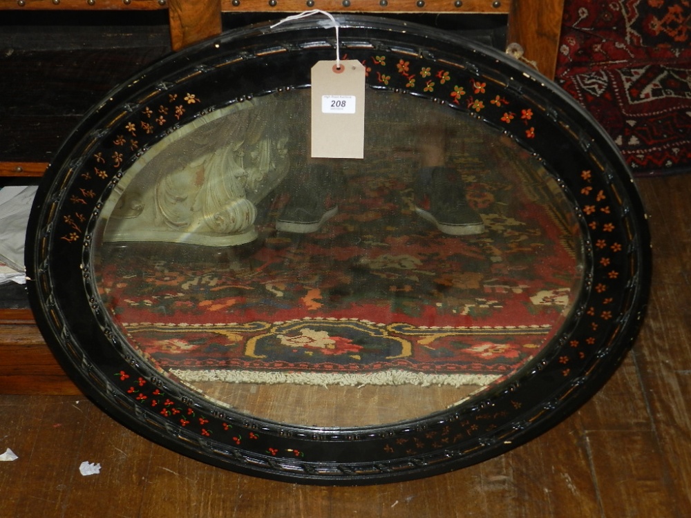 A Victorian oval wall mirror, decorated with flower heads within husk and beaded border.