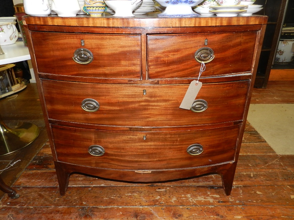 A late George III mahogany bow-fronted chest, fitted two short above two graduated long drawers on