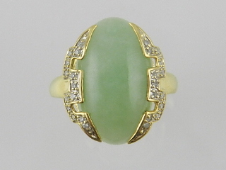 An unusual pale green jade and diamond set yellow metal dress ring in the Art Deco style.