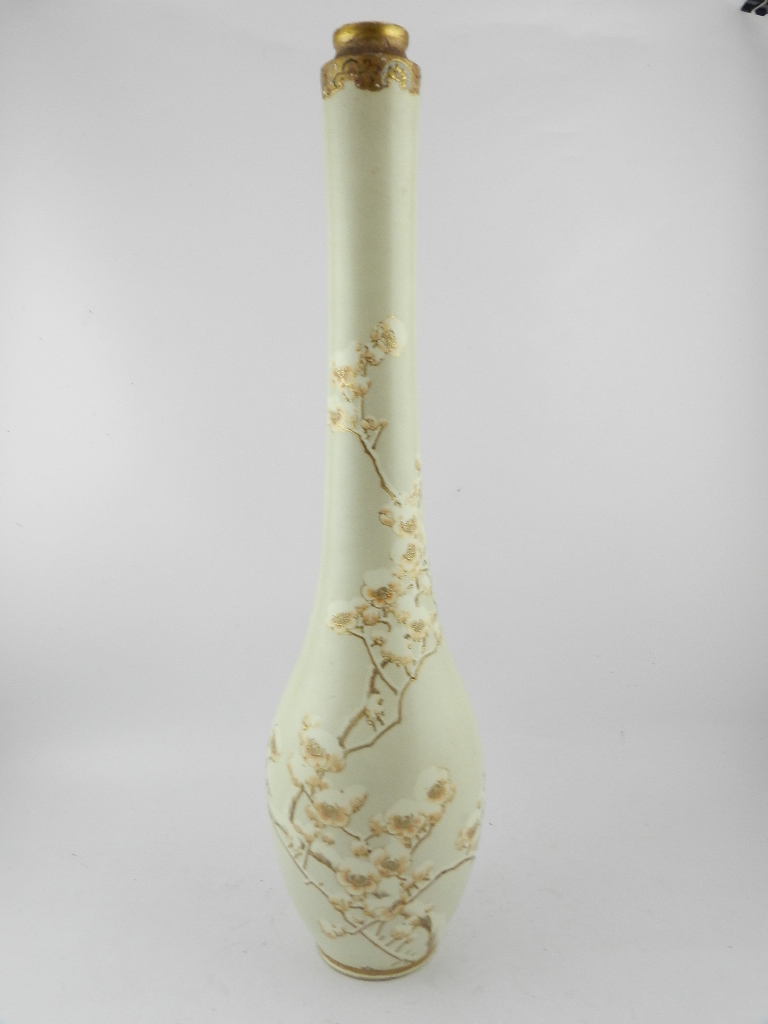 A Japanese late Meiji period satsuma pottery vase of elongated baluster form, decorated with a