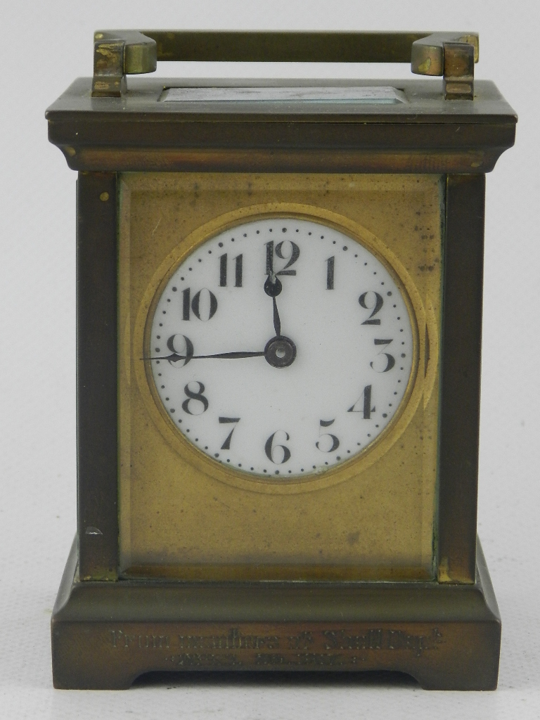 An early 20th century brass carriage time piece, having enamelled Arabic dial, with cylinder