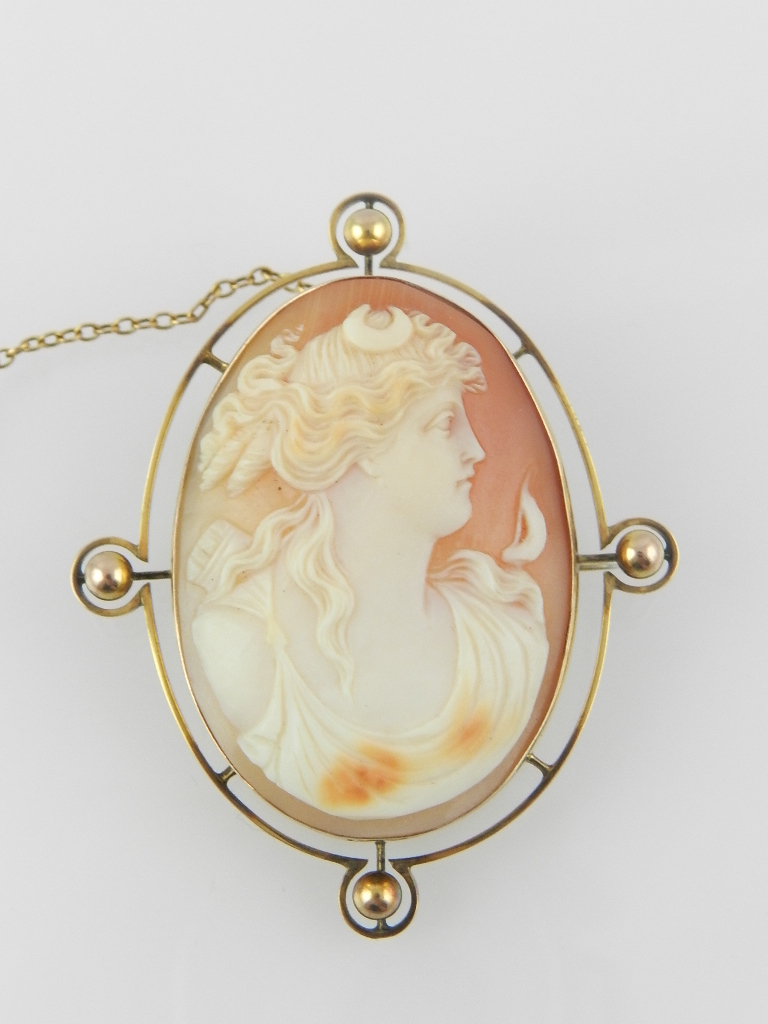 A late 19th century/ early 20th century 9ct yellow gold mounted shell carved cameo brooch, decorated