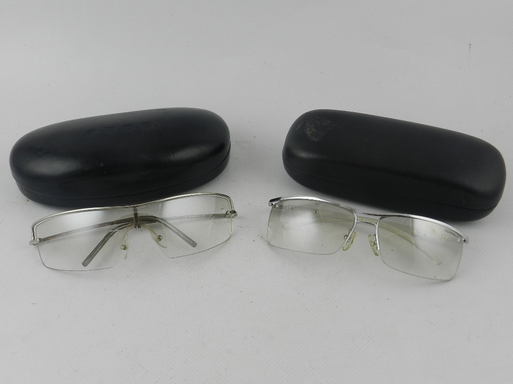 Two pairs of contemporary designer sunglasses, to include Gucci and Chanel, boxed examples.