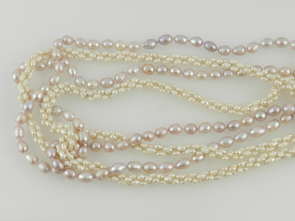 Two cultured pearl necklaces, of pink and natural colour.