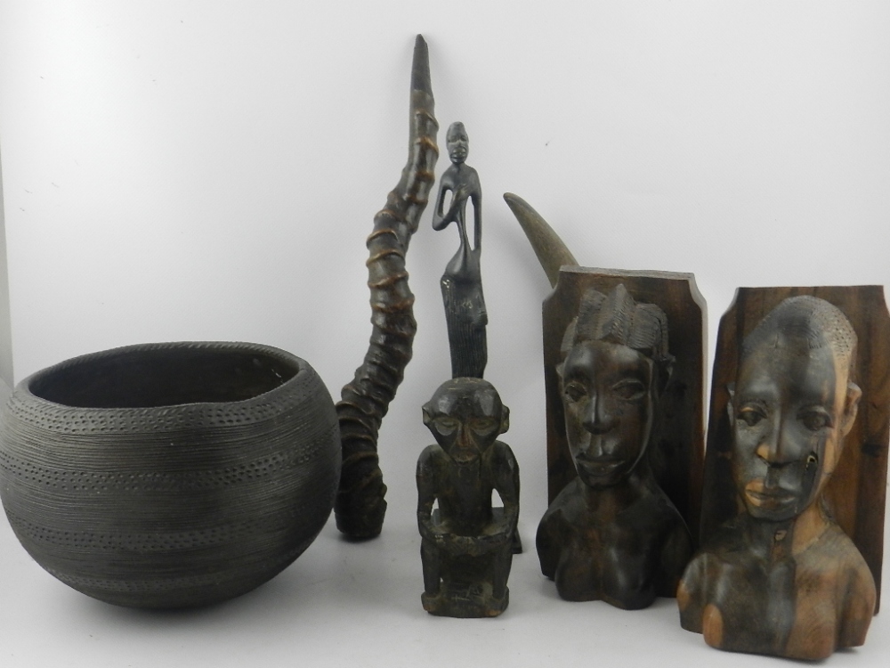 A collection of ethnic items to include a bronze figure, a pair of hardwood bookends, in the form of