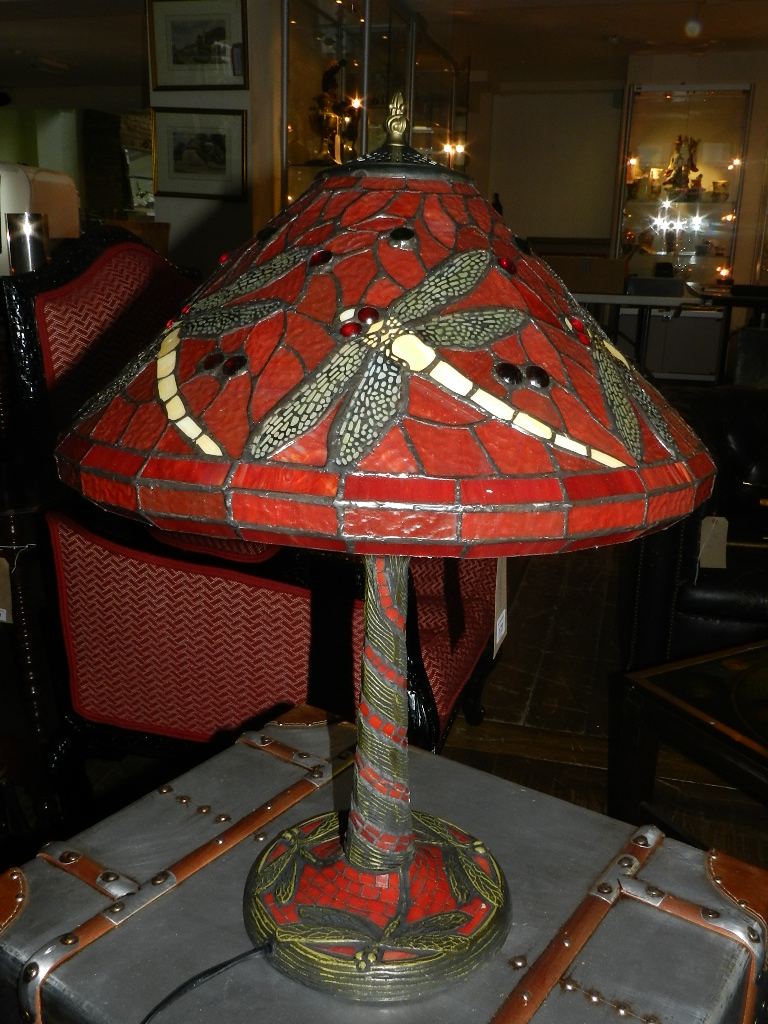 A contemporary Tiffany style glass table lamp, the leaded shade decorated with dragonflies above a