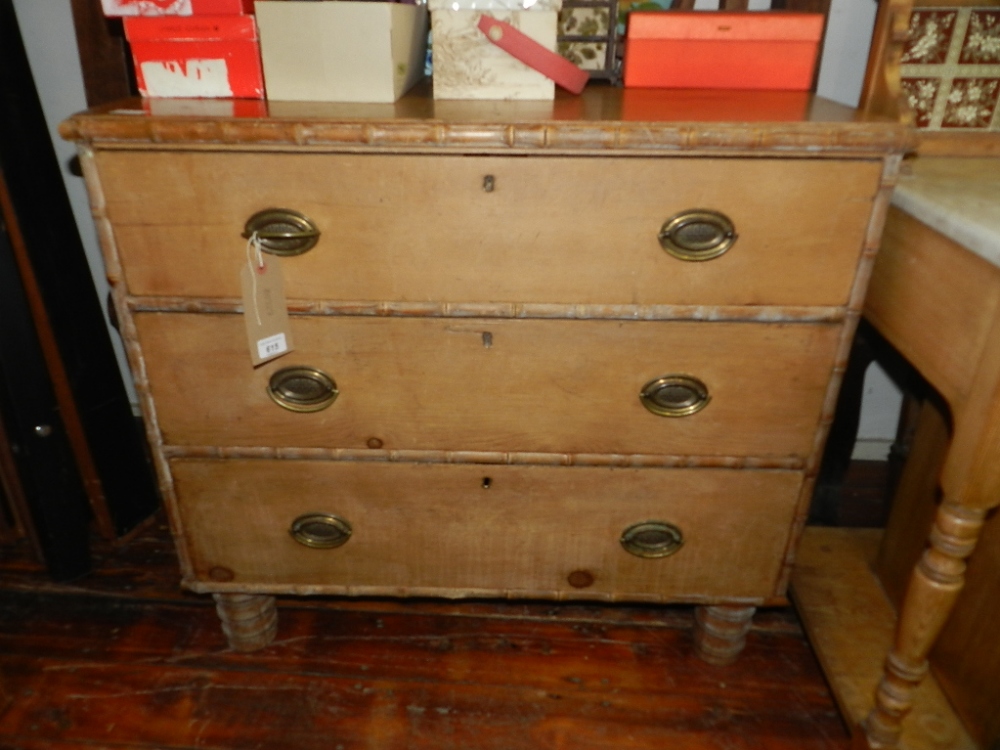 A late George III simulated bamboo pine chest, fitted three graduated long drawers, raised on turned