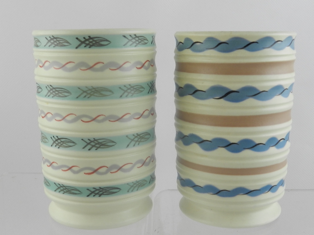 Two mid 20th century Poole pottery vases, decorated in geometric band pattern.