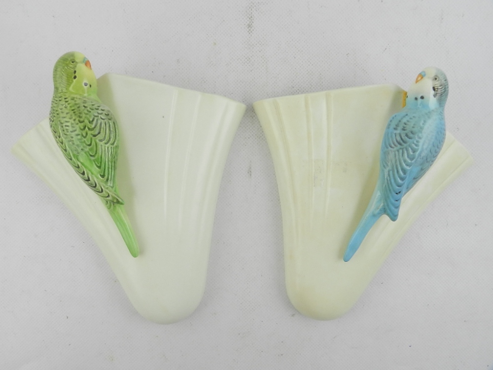 A near pair of Sylvac pottery budgerigar wall pockets, no. 1956.