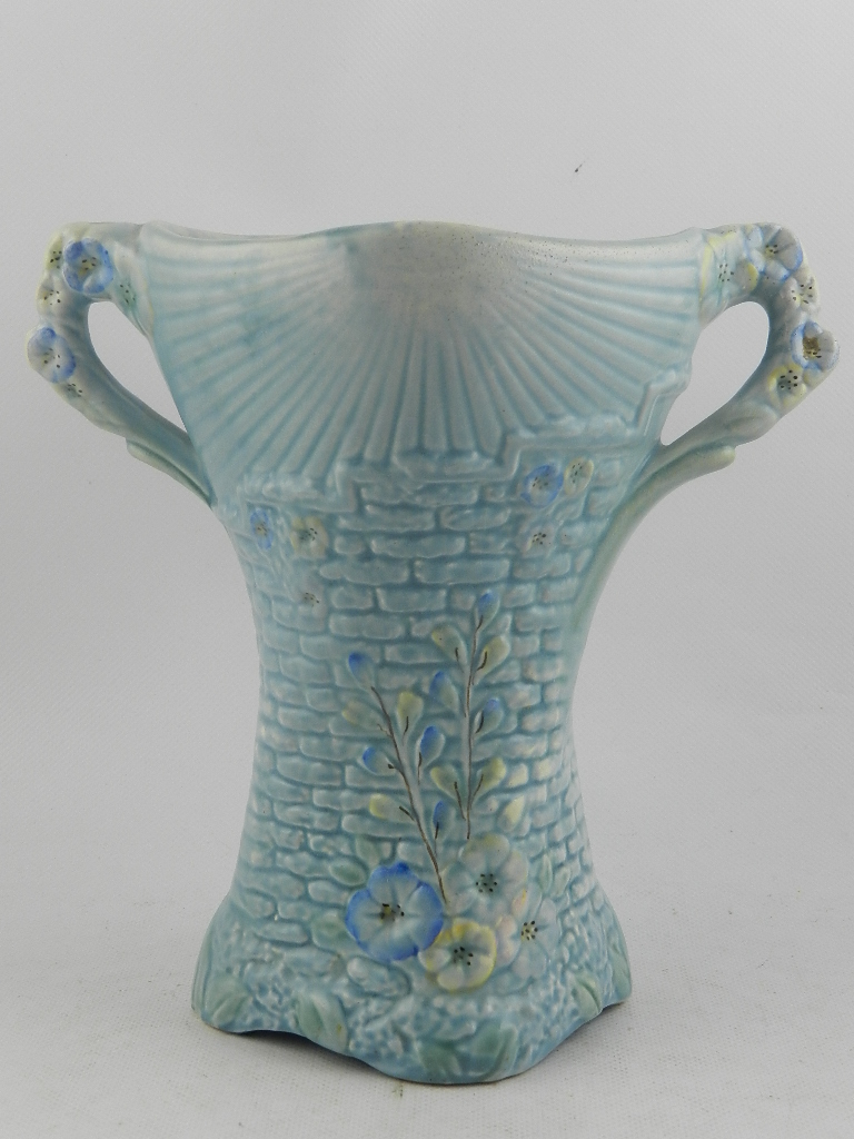 An Arthur Wood pottery twin handled vase, modelled as a garden wall with climbing flowers. H: 24cm