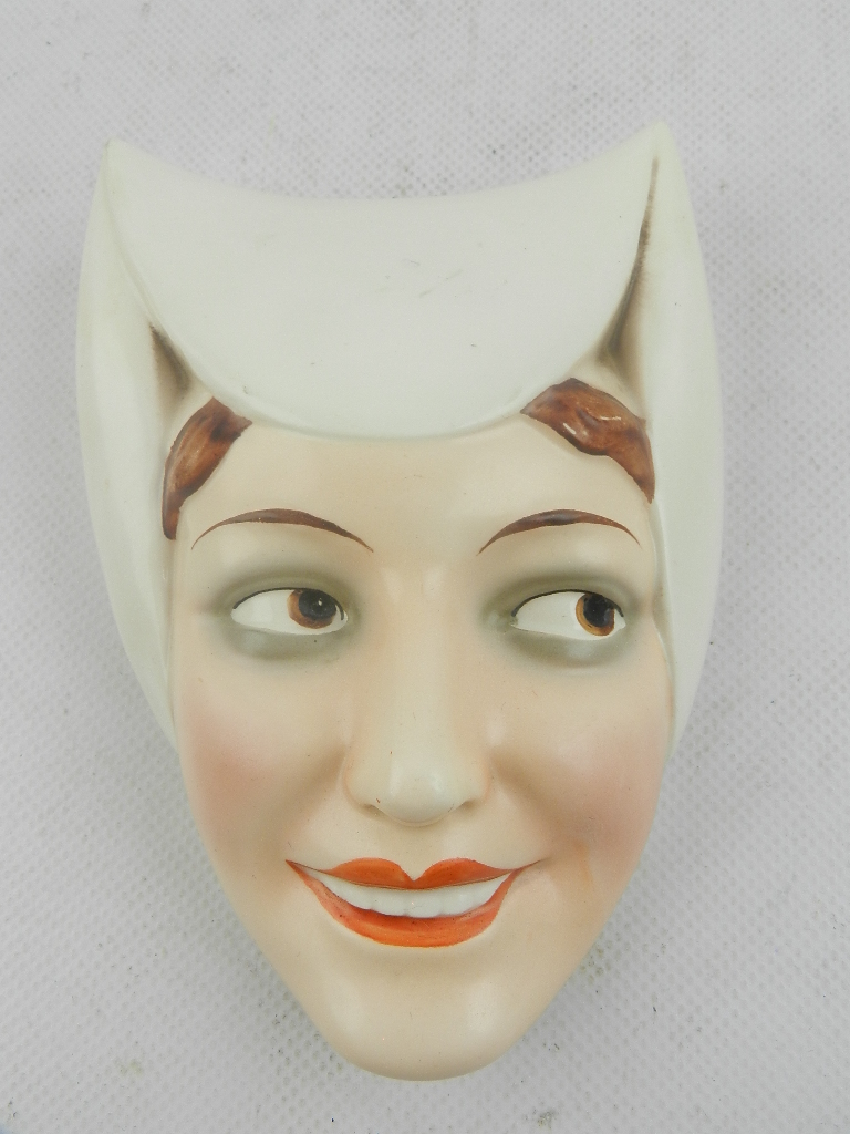 A Goebel ceramic wall mask fashioned as a medieval lady with headdress. H: 16cm