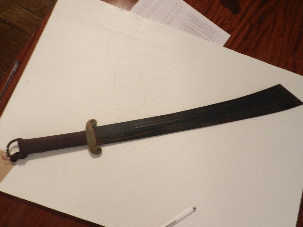 An unusual steel and brass Chinese executioners sword., hilt bears inscription. L.86cm