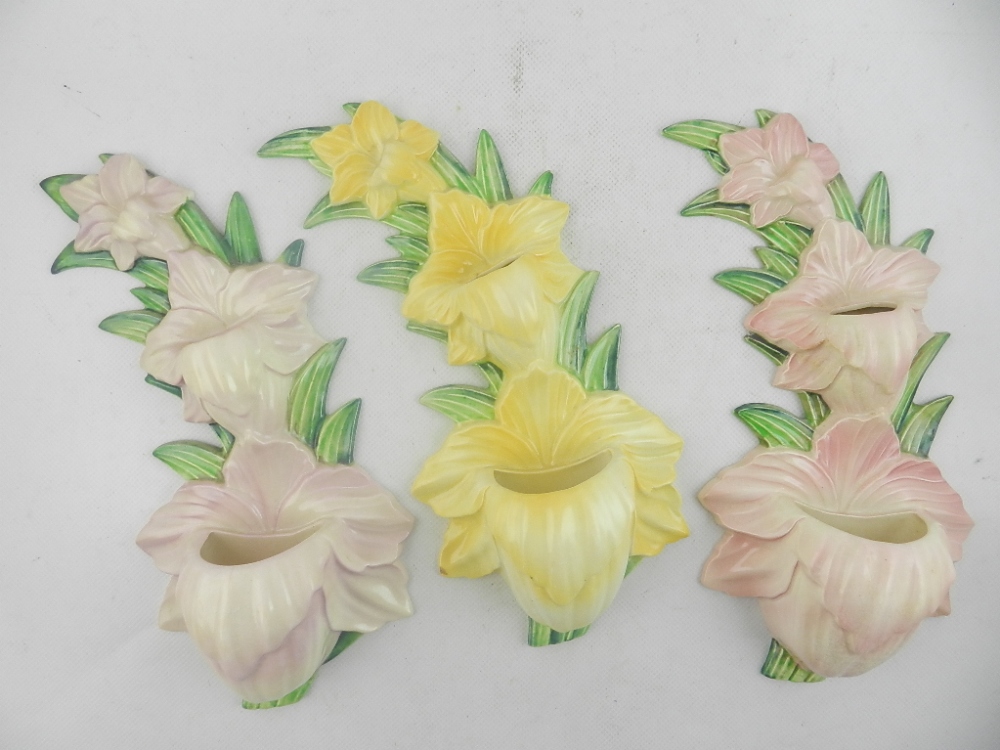 A pair of Carlton ware flower wall pockets, together with one other near matching example. H: 31cm