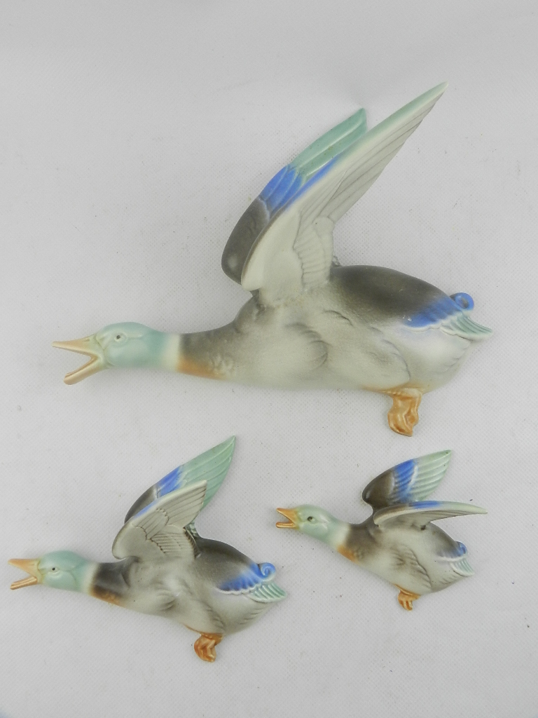 A graduated set of three Poole pottery flying mallards, the largest L: 29cm