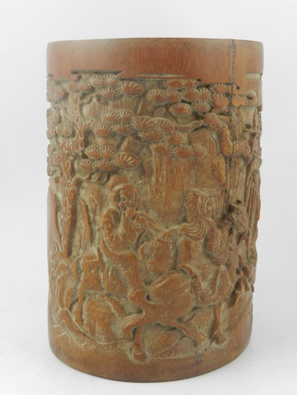 A 20th century relief carved bamboo brush pot, decorated with study of travellers within a
