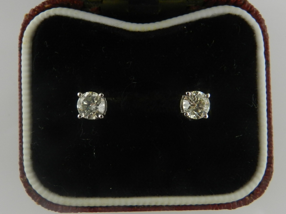 A pair of 18 carat white gold and diamond stud earrings with screw backs, the diamonds of approx.