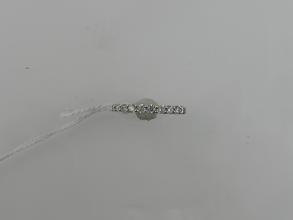 An 18 carat white gold and diamond eternity ring, the diamonds of approx. 1.75 carats combined. Ring