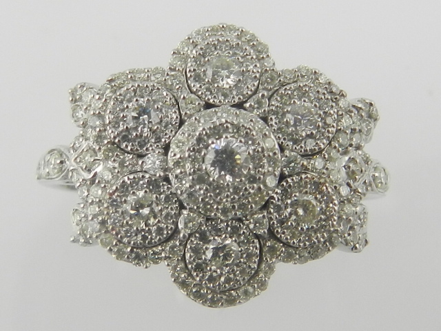 An 18 carat white gold and diamond cluster ring of floral design, set diamonds of approx. 1.23