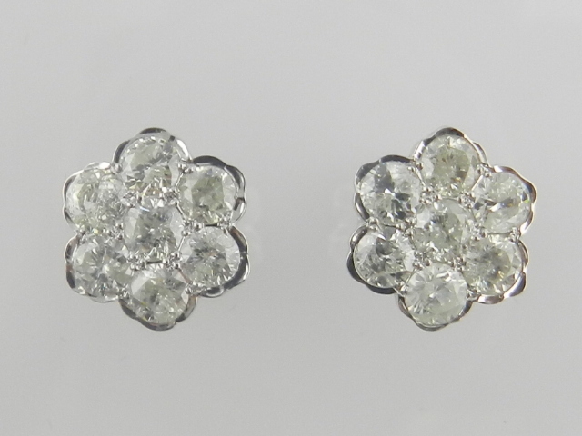 A pair of 18 carat white gold and diamond daisy cluster earrings, the diamonds of approx. 2.07