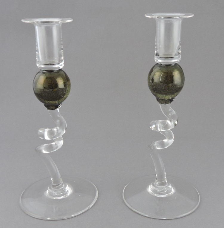 A pair of contemporary hand-blown clear glass candlesticks, the nozzles above a bronzed knop on