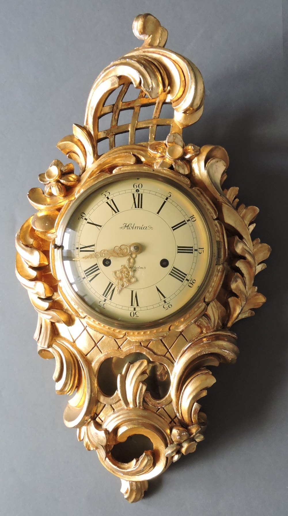 A Swedish giltwood Cartel clock by Holmia, Stockholm. The eight-day movement striking on a bell,