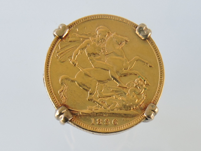 A Victorian sovereign mounted onto a ring, 1897, the claw setting on a 9ct gold band, 13.2g.