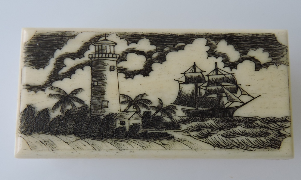 A rectangular bone box with two masted ships passing a lighthouse, 6.5cm.