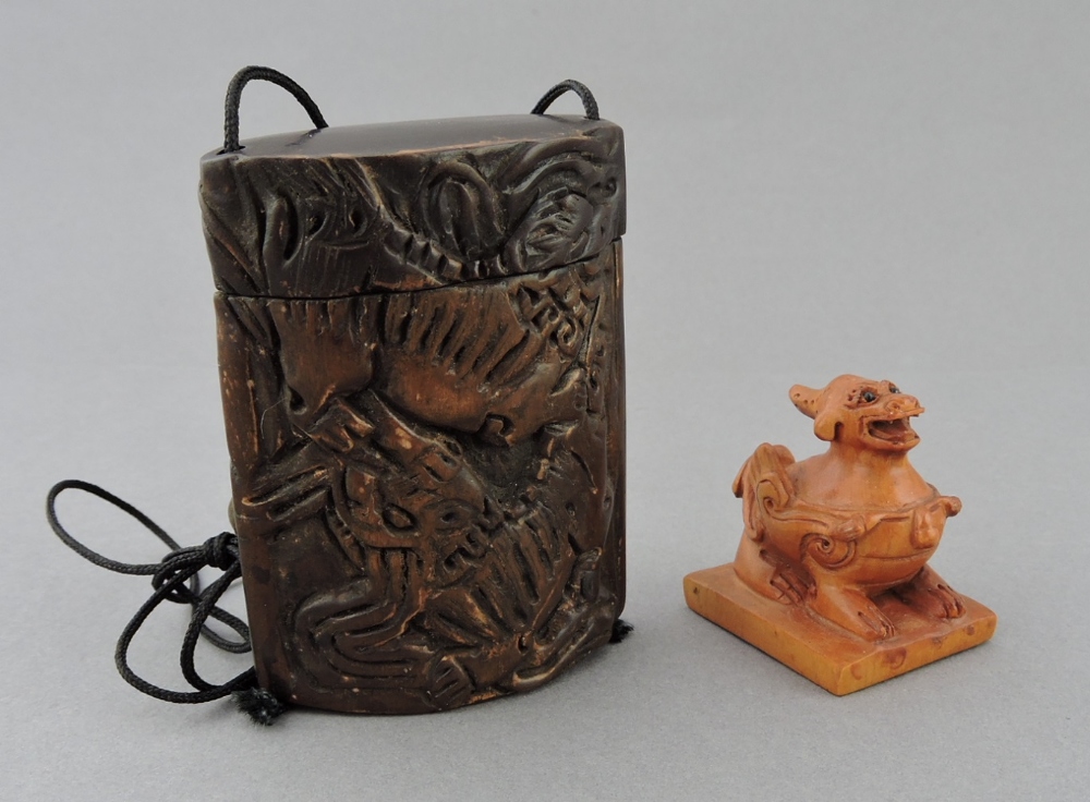 A 20th century carved hardwood netsuke in the form of a dragon, the base with signature, H. 4cm;