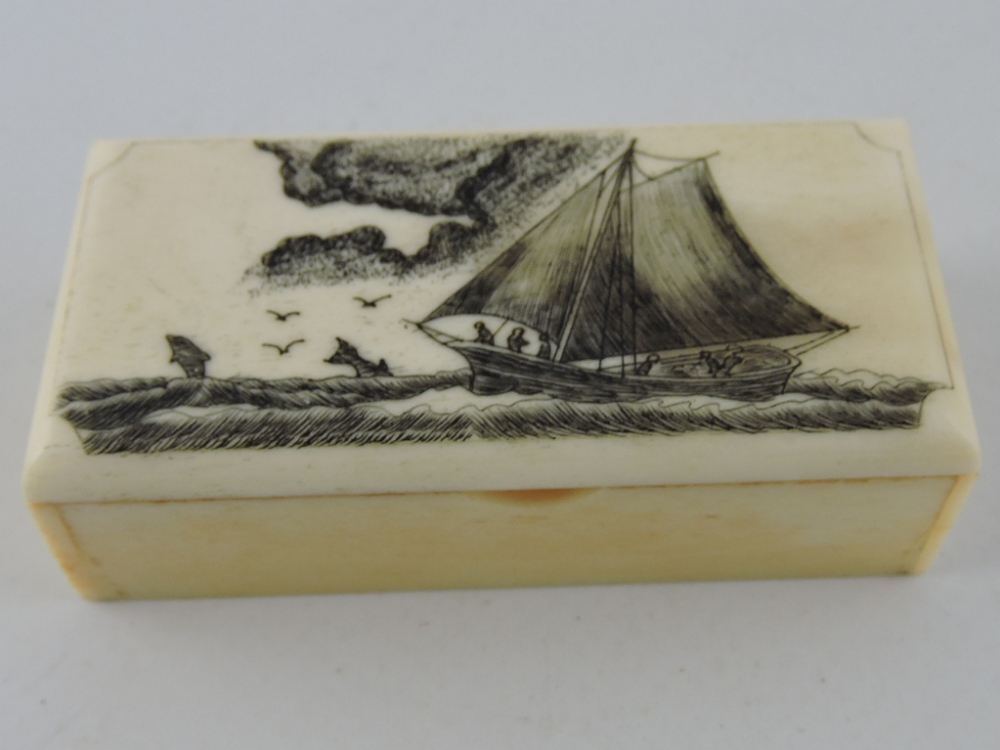 A rectangular scrimshaw style bone box, decorated with a schooner at sea, W. 6cm.