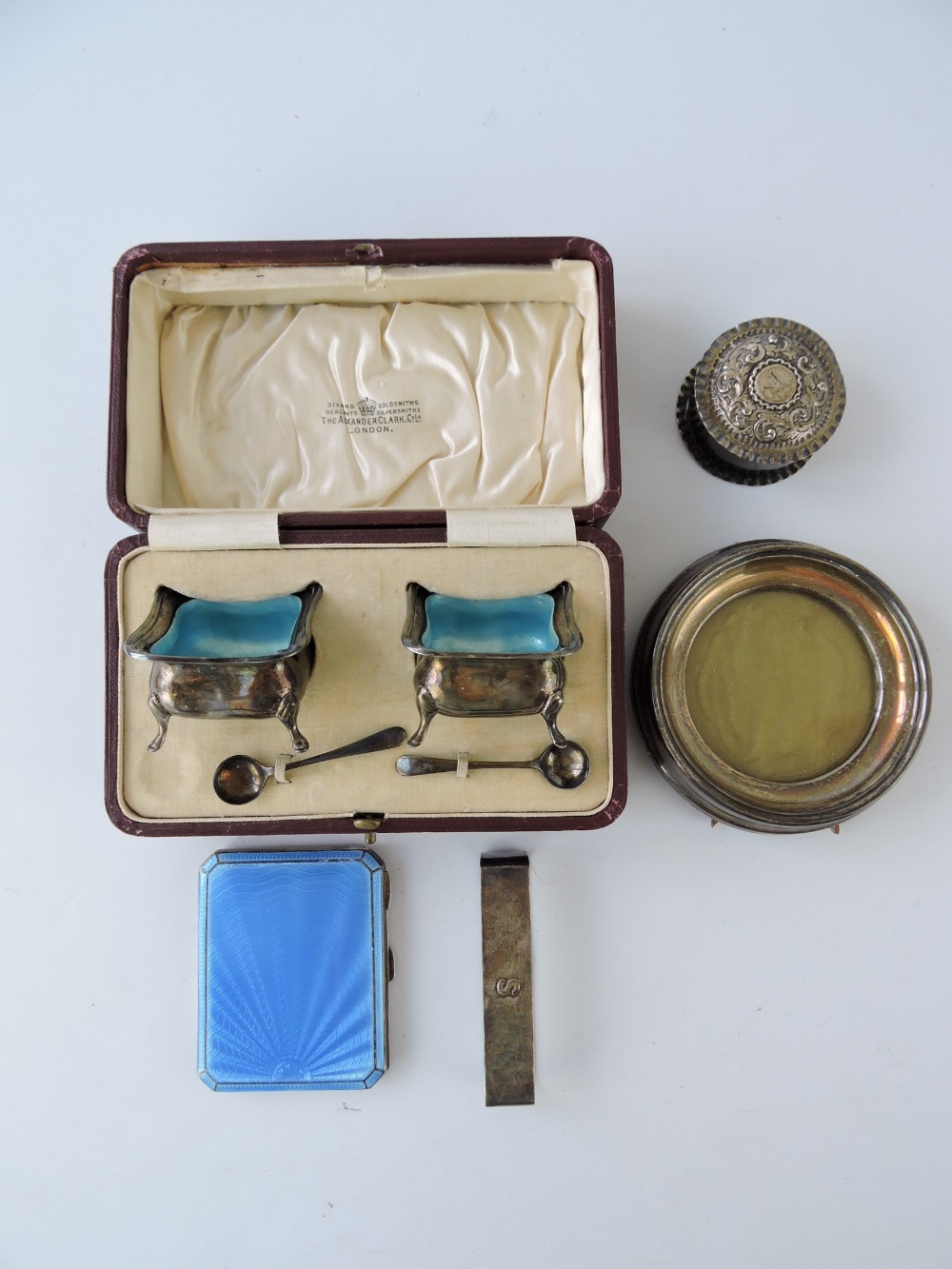 A pair of silver salts in presentation box, the square caldron type salts with an iridescent