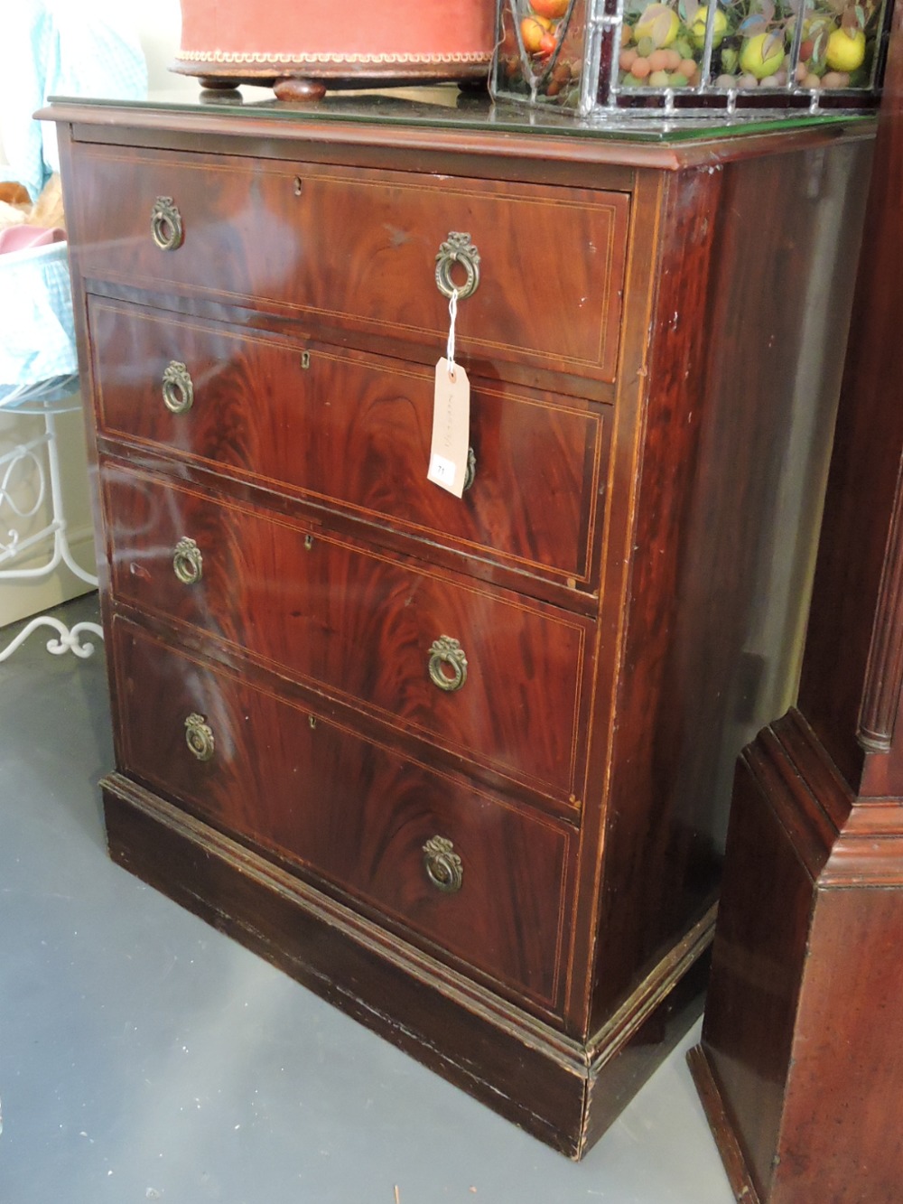 An Edwardian satinwood strung mahogany chest fitted with four graduated drawers on a plinth foot.