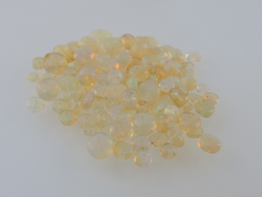 A quantity of opal beads, drilled, approx. 6.7g.